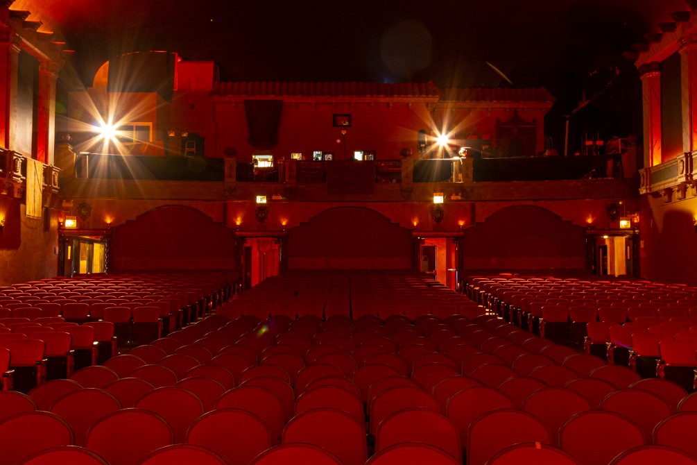 Rows of red seats in the main auditorium viewed from the main stage perspective